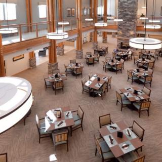 A spacious and modern restaurant interior with neatly arranged tables and chairs.