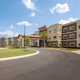 A modern residential apartment building with well-maintained landscaping.