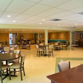 A spacious and modern dining area with tables and chairs, ready for guests.