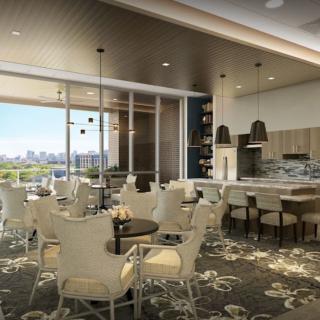 A modern dining area with elegant furnishings and a view through large windows.
