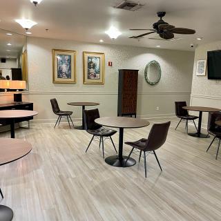 An empty modern restaurant interior with tables and chairs neatly arranged.