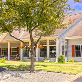 A charming suburban house with a well-maintained front yard and landscaping.