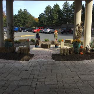 A welcoming outdoor seating area with planters, surrounded by a beautiful landscape, perfect for enjoying the autumn weather.