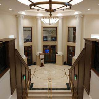 An elegant lobby showcasing classic architectural elements and a grand chandelier.