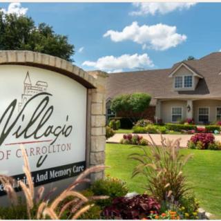 A retirement community sign in a well-landscaped area with a residential building in the background.