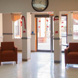 A well-lit lobby with comfortable chairs and festive decorations.
