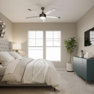 A modern and cozy bedroom featuring neutral tones, a plush bed, a stylish dresser with a mirror, and a ceiling fan.