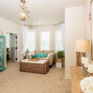 A cozy living room with stylish furniture and bright natural lighting.