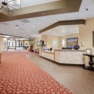 A welcoming hotel lobby with a reception desk and comfortable decor.