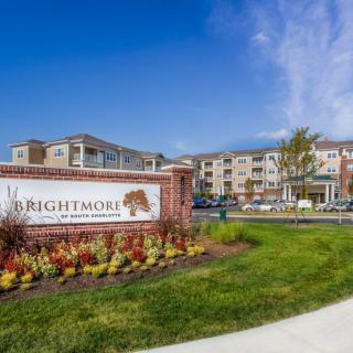Entrance to Brightmore Retirement Community with well-maintained landscaping.