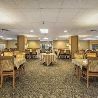A spacious dining room with neatly arranged tables and chairs.