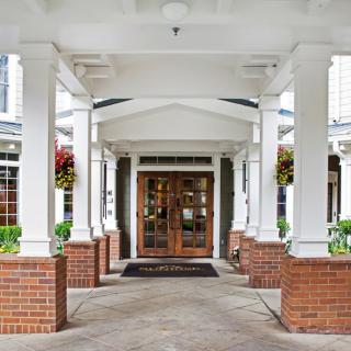 Grand entrance with columns and brickwork.