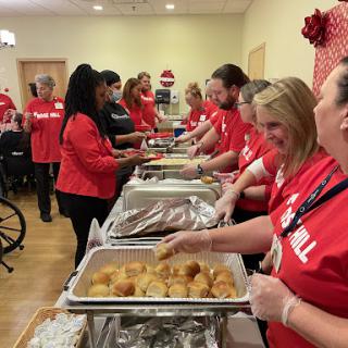 Volunteers serving food at a community event, spreading joy and warmth during the holiday season.