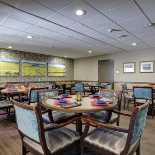 A cozy dining area with neatly arranged tables and chairs, showcasing elegant decor and place settings.