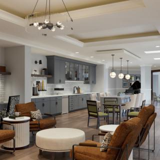 A modern kitchen and seating area with contemporary furnishings and lighting.