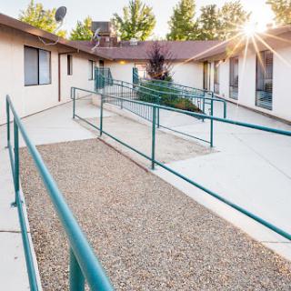 An accessible pathway with ramps illuminated by sunlight.