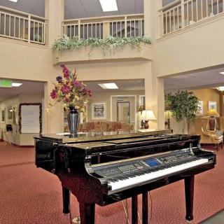 A grand piano in an elegantly decorated hotel lobby.
