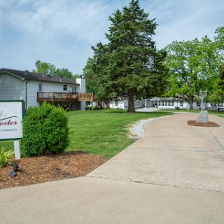 A welcoming entrance with a well-maintained pathway leading through landscaped grounds.