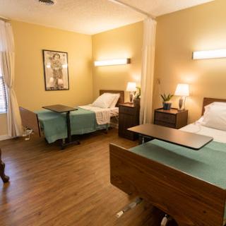 A spacious hospital room equipped with two beds, providing a comfortable environment for patients.
