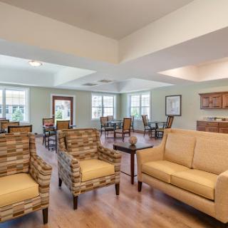 A cozy and inviting community living area featuring comfortable seating and ample natural light.