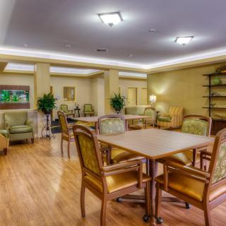 A cozy dining and lounge area with tables, chairs, and soft lighting.