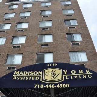 A view of the Madison York assisted living building with its prominent entrance awning.
