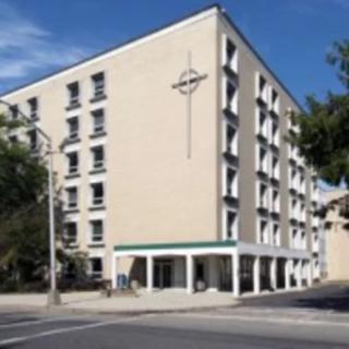 A modern multi-story hotel building in an urban setting.