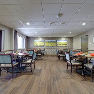 An empty dining area with several tables and chairs arranged neatly.