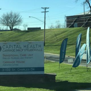 Signage for Capital Health, indicating a healthcare facility with promotional flags.