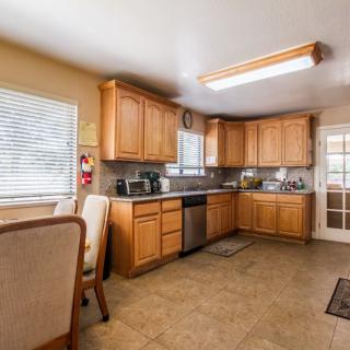 A clean and spacious kitchen with wooden cabinets and modern appliances.