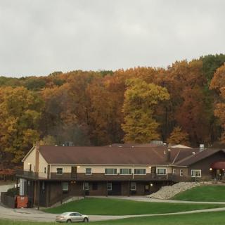 A large building surrounded by vibrant fall foliage.
