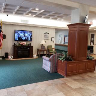 A welcoming lobby area featuring comfortable seating and a television, creating a cozy environment.