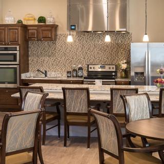 A modern kitchen with dining area featuring upscale appliances and elegant furnishings.