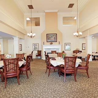 A spacious dining room with elegantly set tables and classic decor.