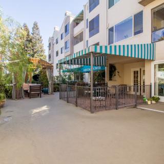 Outdoor view of a residential building with a patio and awning.