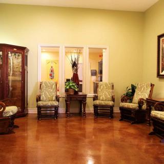 A cozy living room with elegant wooden furniture and warm lighting.
