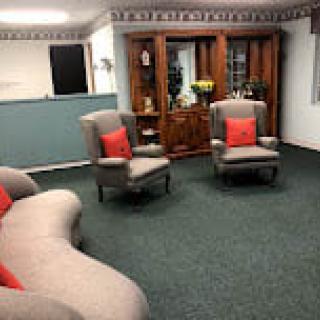 A cozy living room with comfortable seating and decorative elements.