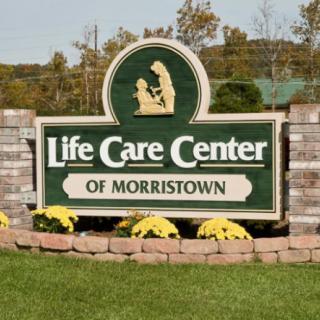 Sign for Life Care Center of Morristown surrounded by flowers.