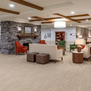 A modern lobby with comfortable seating and a cozy fireplace.