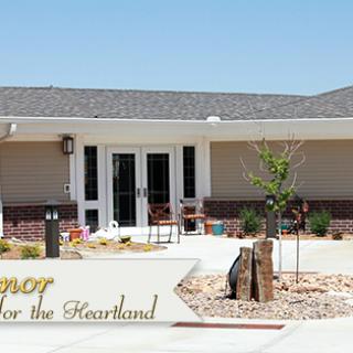 Front view of a community center with landscaped entrance and prominent signage.