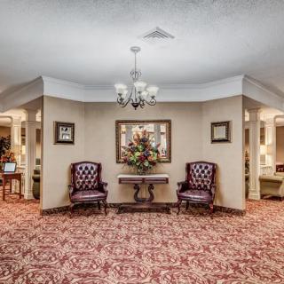 Elegant lobby area with patterned carpet and classic furniture.