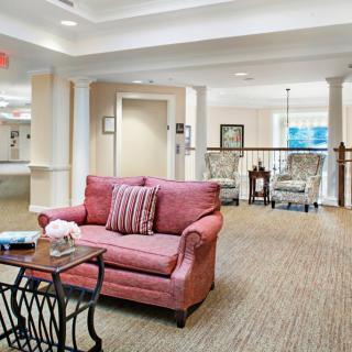 A cozy living room interior with a red sofa and elegant decor.