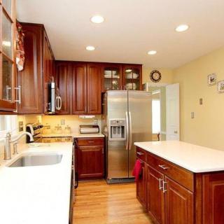 A modern kitchen with wood cabinets and stainless steel appliances.