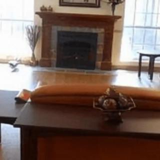A cozy living room featuring a fireplace and comfortable seating arrangement.