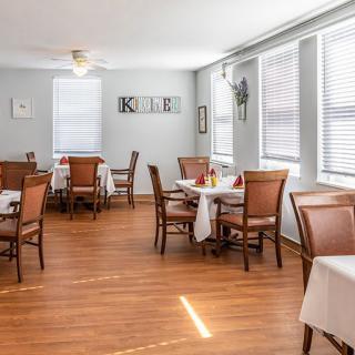 A bright and inviting dining room with neatly arranged tables and chairs.