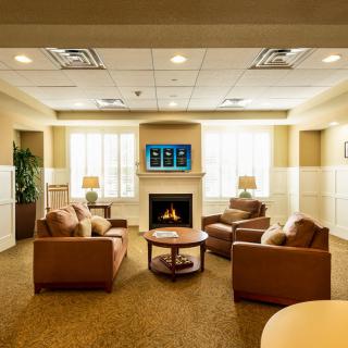 A cozy lounge area featuring comfortable armchairs and a fireplace.