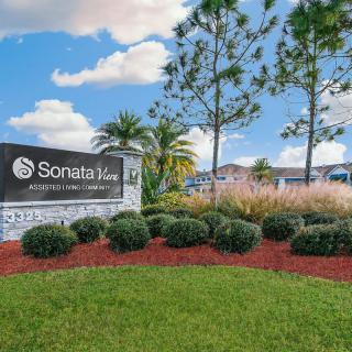 Entrance sign for Sonata West surrounded by well-maintained landscaping and trees.