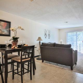 A cozy living and dining area with modern furniture and elegant decor.