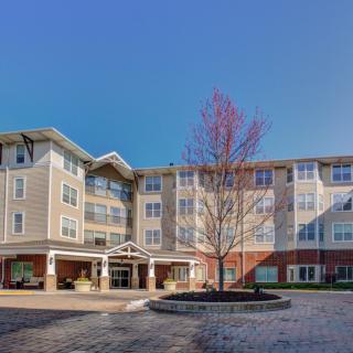 A modern residential apartment building under a clear blue sky.