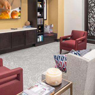 A modern living room with stylish furniture and a television centerpiece.